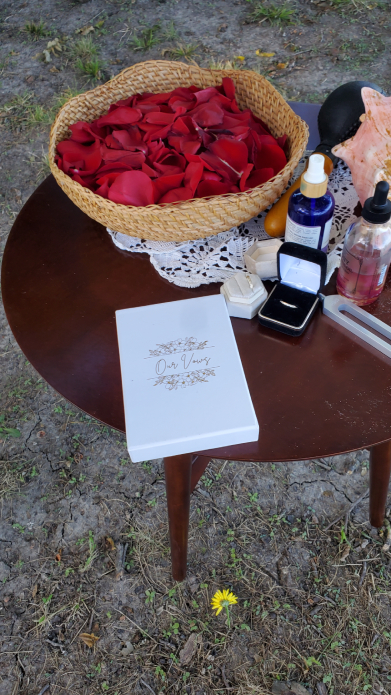 Mayan wedding ritual table with rose petals, oils, rings, and ceremonial items
